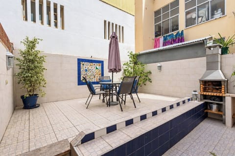Generous private patio with outdoor seating and a built-in barbecue for relaxed meals outside.