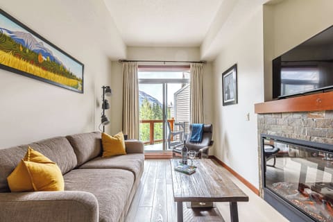 Living room comfort, elevated by a fireplace and a smart TV