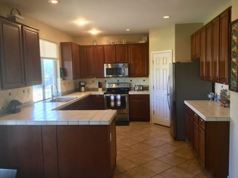 Fully stocked kitchen, large walk in pantry, dishwasher, views of lovely yard