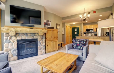 Cozy living room with TV and fireplace.