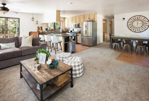 Gorgeous open living, dining, and kitchen area with a deck. New flooring added to the kitchen, living room, dining room and hallway! 