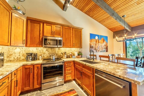 Remodeled kitchen has solid stone countertops.