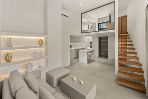 The Living Room, Dining Area, and Staircase Leading to the Mezzanine
