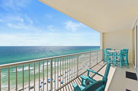 【Private Balcony】 16th floor Gulf front — teal chairs face the water, dolphin sightings most mornings.
