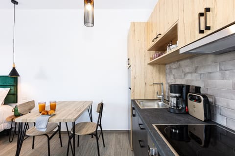 Kitchenette area for culinary creations and dining table. Enjoy your meals.