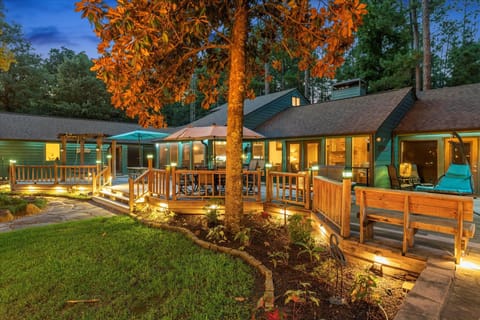 The deck is beautifully illuminated with soft lighting, from fixtures in the trees to lights beneath the deck. This gentle glow creates a magical ambiance, making it easy to see and move around while maintaining a relaxing, cozy atmosphere for evenings out