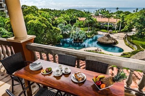 Outdoor dining with ocean and resort pool views