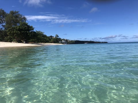 On the beach, white sand, sun loungers, beach towels