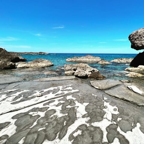 Beach nearby, black sand, beach umbrellas, beach towels