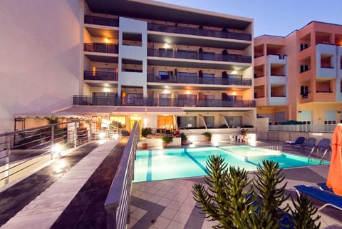 Seasonal outdoor pool, open 9:00 AM to 8:00 PM, pool umbrellas
