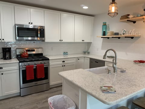 Dishwasher, gas stove, and farm sink