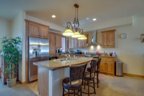 Your gourmet kitchen invites memorable meal preparation with granite counters, premium appliances, and a cozy breakfast bar perfect for morning coffee.