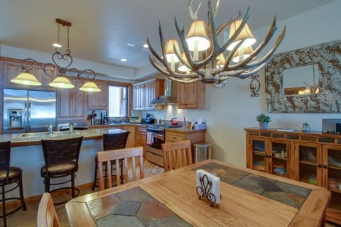 You'll love gathering around this rustic dining table beneath the stunning antler chandelier, while the gourmet kitchen invites culinary adventures.