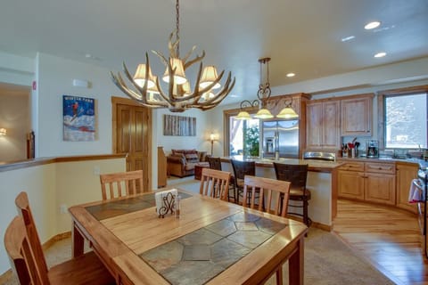 Gather around your rustic dining table under the antler chandelier while savoring mountain views from your fully equipped kitchen.