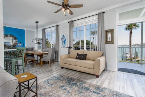 Bright coastal living room with comfortable seating and beautiful harbor views.