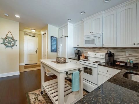 Kitchen - fully equipped w/ a microwave, dishwasher, full size fridge, Mr. Coffee, range, stackable washer/dryer, pots/pans, dishes and silverware.