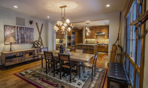 Step into your mountain retreat where rustic elegance meets modern comfort. The warm wood dining table awaits your family meals, while the gourmet kitchen beckons culinary adventures.