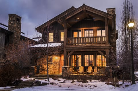 Step into your mountain retreat where warm light spills from every window, welcoming you home after snowy adventures. Relax on your private balcony with a hot cocoa as twilight paints the sky.