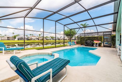 Step into your private oasis, where the sparkling pool invites you to unwind on comfortable striped loungers. Surrounded by a screened enclosure, enjoy panoramic views of lush greenery that enhance your relaxation experience.