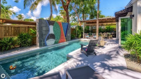 The heated pool gets lots of sun throughout the day and features a distinctive mosaic waterfall wall...