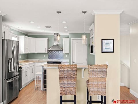 Modern kitchen with sleek appliances and cozy breakfast bar seating