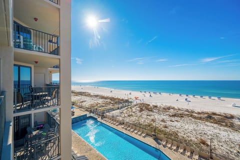 Enjoy the inviting pool area, perfect for relaxation, with stunning views of the beach and clear blue waters