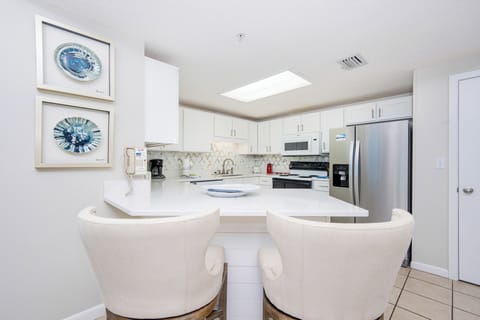 Enjoy casual meals at the sleek breakfast bar, surrounded by stylish decor and a welcoming atmosphere