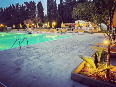 Seasonal outdoor pool, open 9:00 AM to 7:00 PM, pool umbrellas