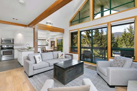- Bright open-concept living with mountain views through floor-to-ceiling windows  
- Modern furniture, vaulted ceilings, and natural wood beams create inviting warmth  
- Relax after outdoor adventures in this stylish mountain getaway  
