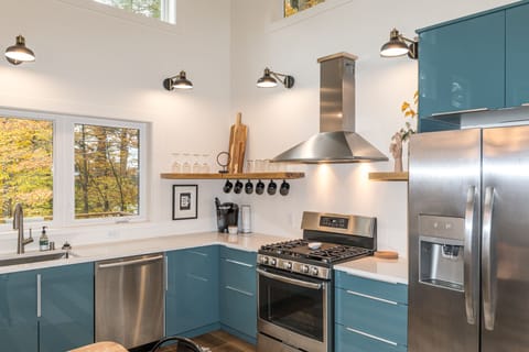 The kitchen includes brand-new appliances and cabinets stocked with dishes