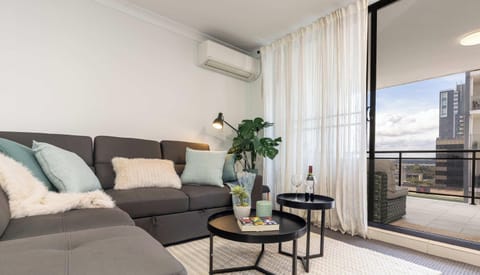 Living area  with modular lounge opens up onto oversized balcony