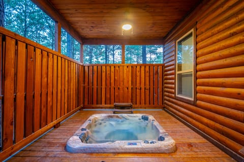 Relax in the large inset hot tub surrounded by the peaceful forest of Broken Bow.