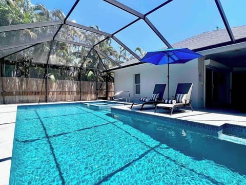 Bask in the sunlight on this beautiful pool deck with screen enclosure. 