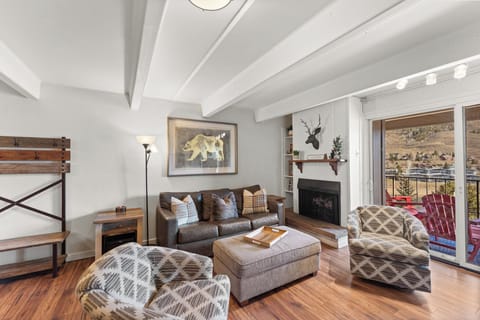 Cozy up in your mountain retreat with exposed beams, leather seating, and a warm fireplace overlooking scenic views.
