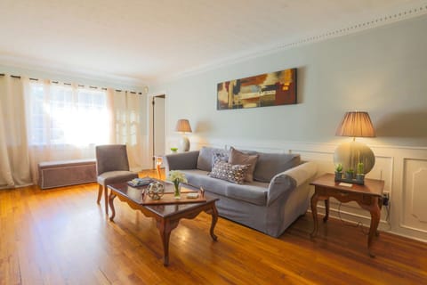This beautifully decorated living room sits very near the home's front door & entryway.