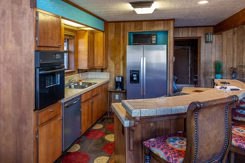 The kitchen features stainless steel appliances and a beautiful island counter