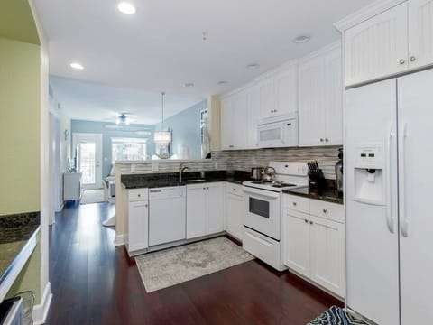 Fully equipped kitchen that inlcudes a microwave, dishwasher, full size fridge, Keurig coffee maker, pots/pans, dishes and even a stackable washer and dryer.