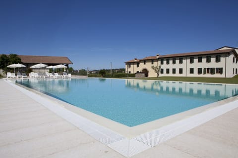 Seasonal outdoor pool, open 8:00 AM to 8:00 PM, pool umbrellas