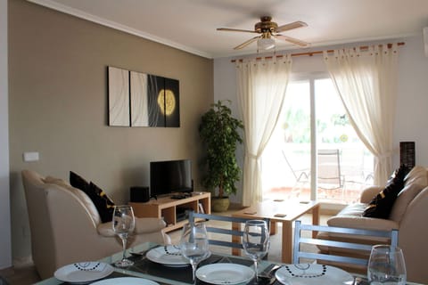 Spacious living room with balcony and views of the Communal pool