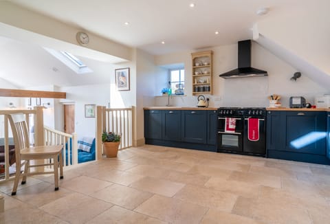 Split level ground floor: Spacious kitchen with steps leading down to sitting room