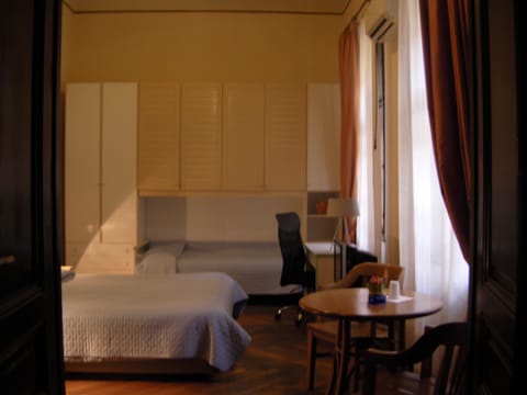 Triple Room, Shared Bathroom | Down comforters, desk, blackout drapes, iron/ironing board