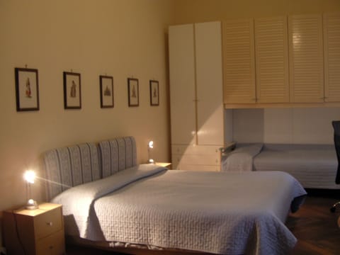 Triple Room, Shared Bathroom | Down comforters, desk, blackout drapes, iron/ironing board