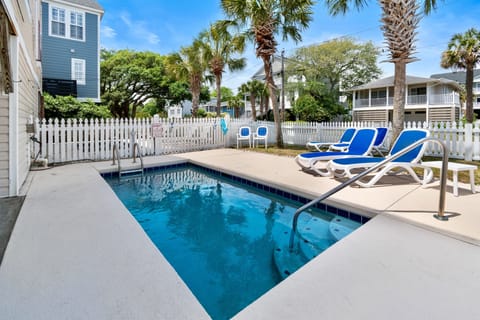 Dive into your private pool paradise, where blue waters meet sunny skies. Lounge poolside surrounded by swaying palms in this perfect beach retreat.