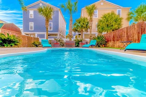 Dive into your private tropical oasis surrounded by swaying palms and vibrant beach houses under endless blue skies.