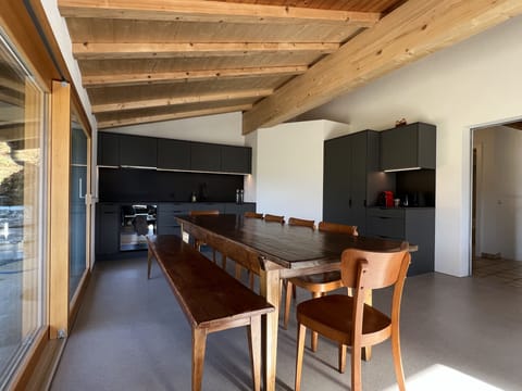 Dining table with kitchen in the background.