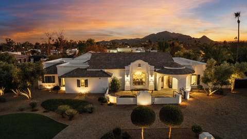 Curb appeal with lighting, landscaping, circular drive, and mountain views