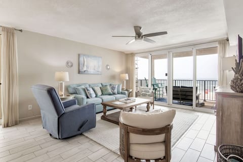 Gulf-front living room with oversized balcony views at Wind Drift Orange Beach