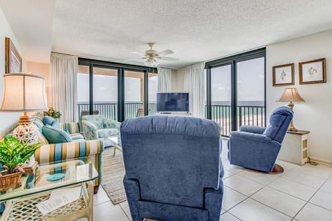 Gulf-front living room with recliners and corner unit views at Wind Drift Orange Beach