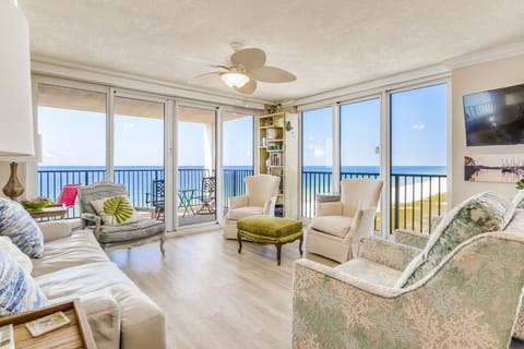 Corner unit living room with panoramic Gulf views and wall of windows at Wind Drift Orange Beach