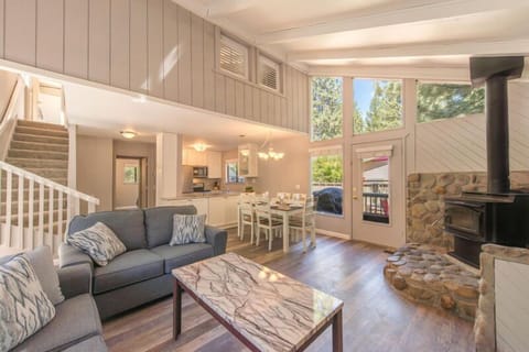 Cozy and clean living room, dining area and kitchen entrance.